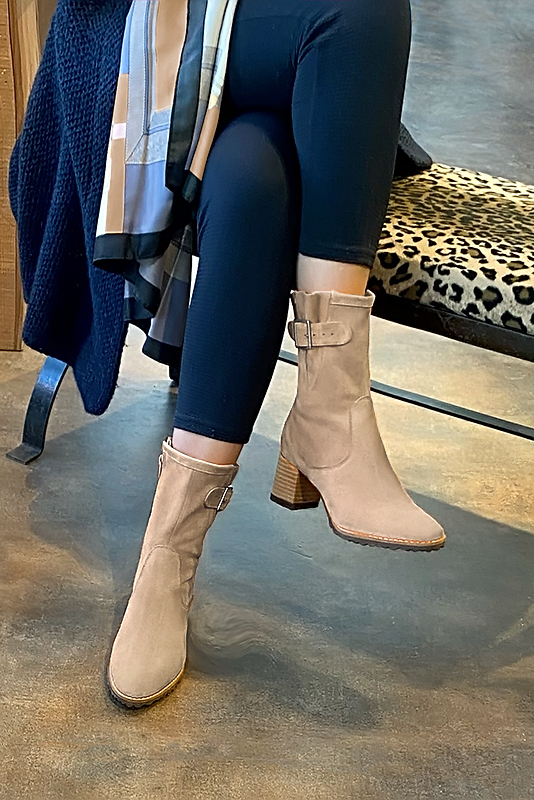 Tan beige women's ankle boots with buckles on the sides. Round toe. Medium block heels. Worn view - Florence KOOIJMAN